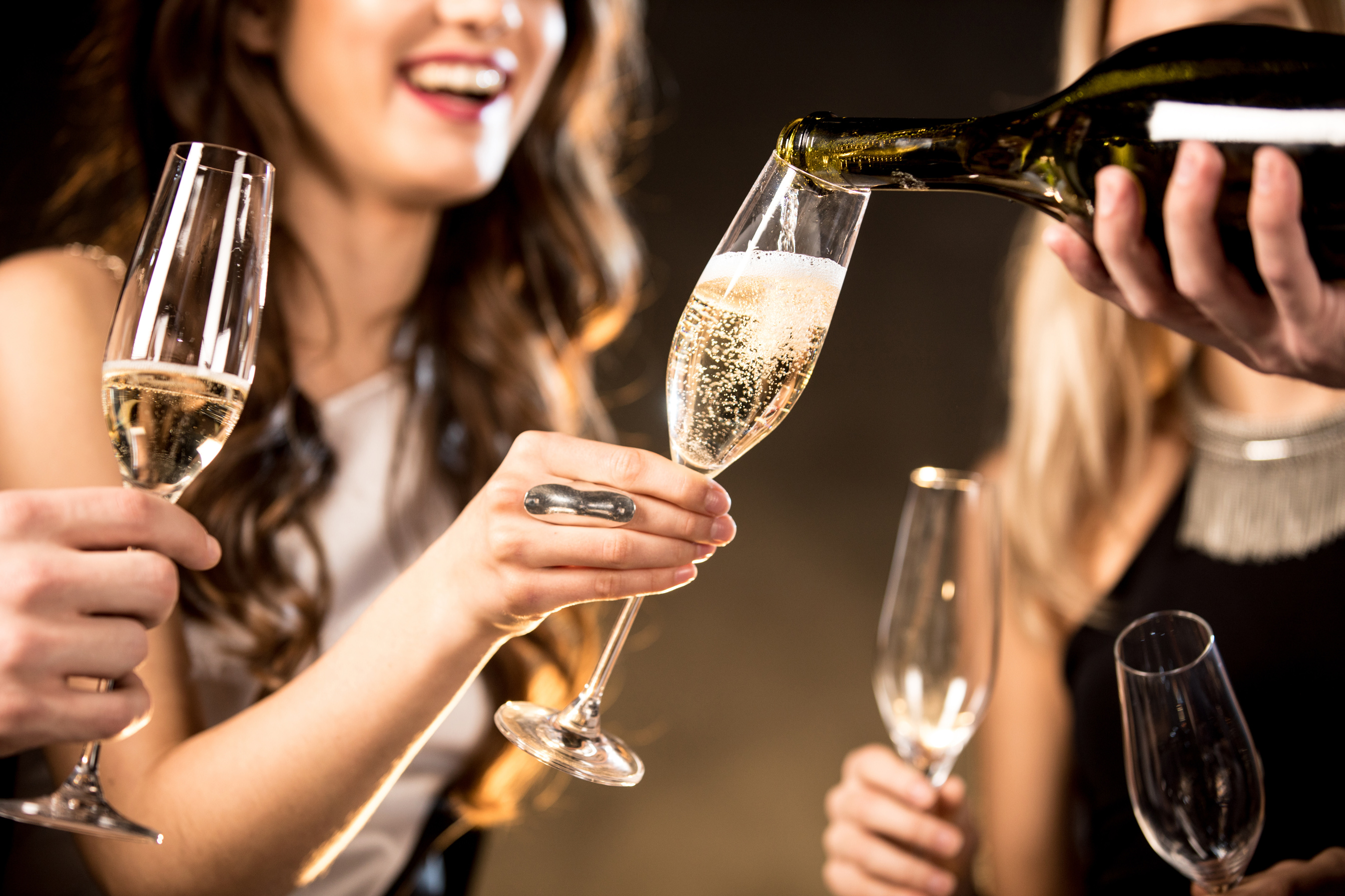 Happy friends drinking champagne